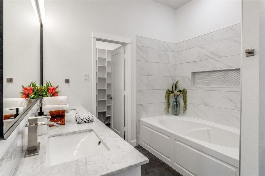 Bathroom with vanity and a tub