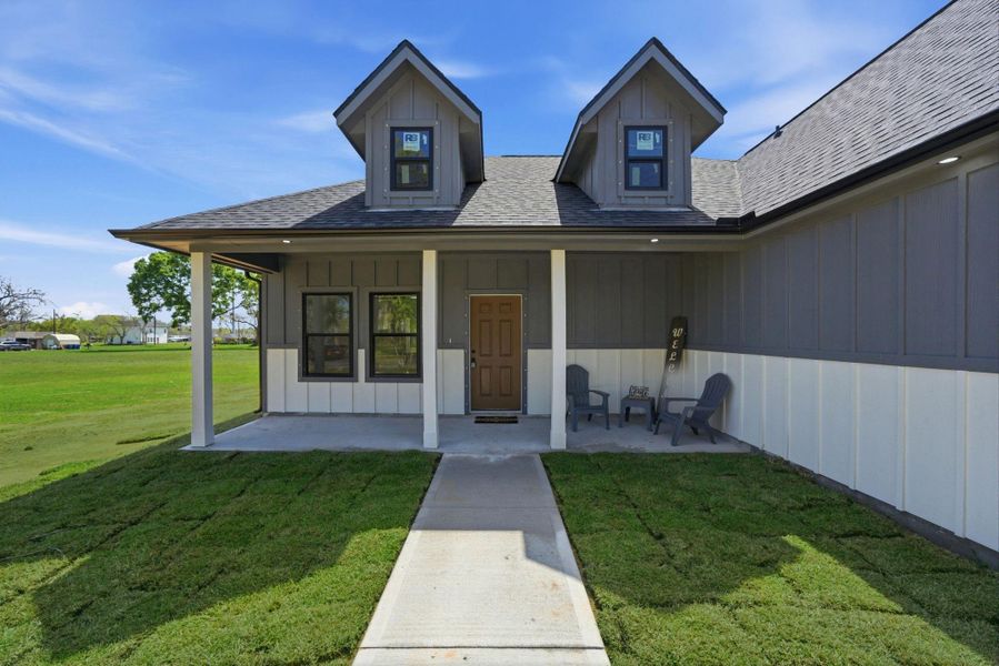 Large covered front patio with plenty of space to enjoy the fresh air. Ready for your personal touches!  (photos of grass have been digitally enhanced for presentation.)