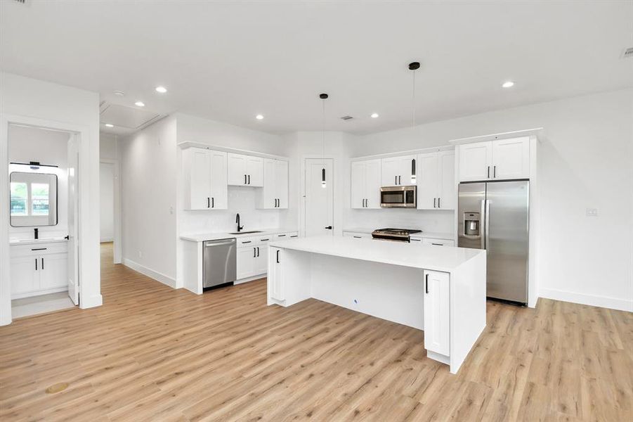 This kitchen is by far any chef’s dream! This spacious kitchen features high ceilings, light colored cabinets, granite countertop, SS appliances, modern tile backsplash, recessed lighting, extended counter space, granite kitchen island and a walk-in pantry all overlooking your huge family room.