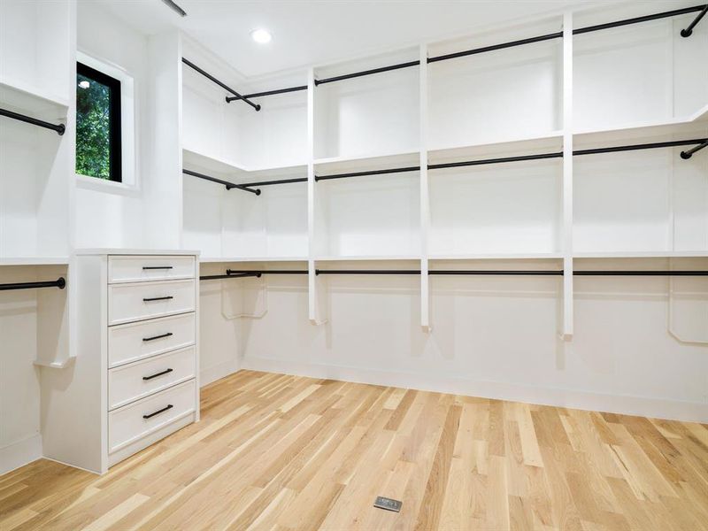 Walk in closet with light wood-style flooring