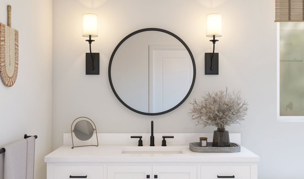 Primary bath with round mirror and sconce lighting