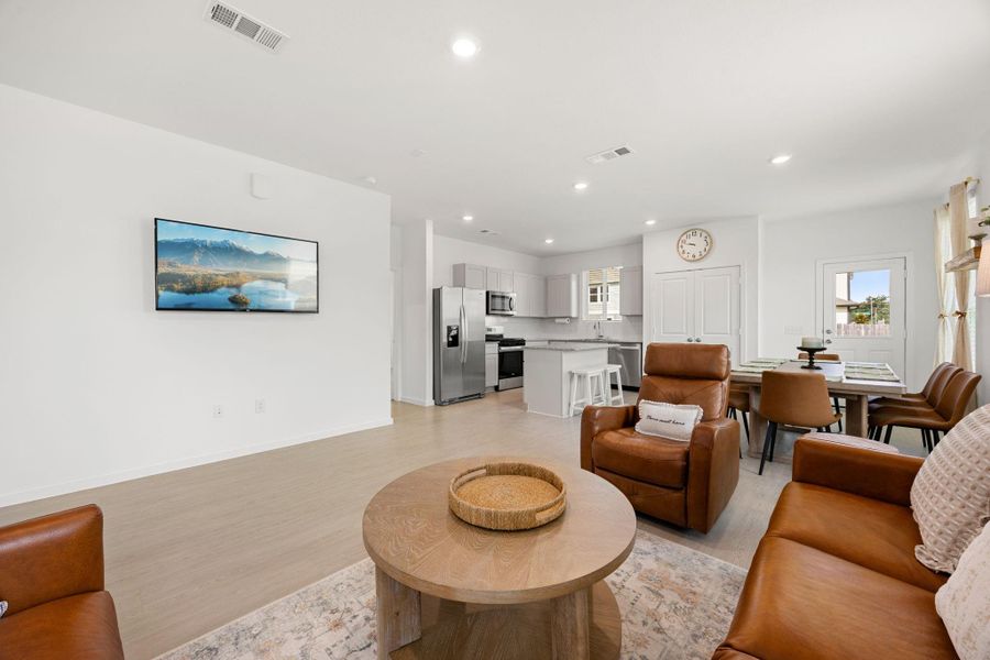 The open-concept layout keeps everyone connected, offering seamless flow between the living room, dining area, and kitchen—perfect for entertaining or everyday life.