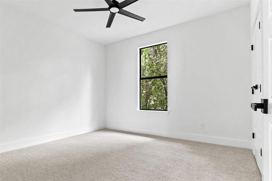 Spare room featuring ceiling fan and carpet