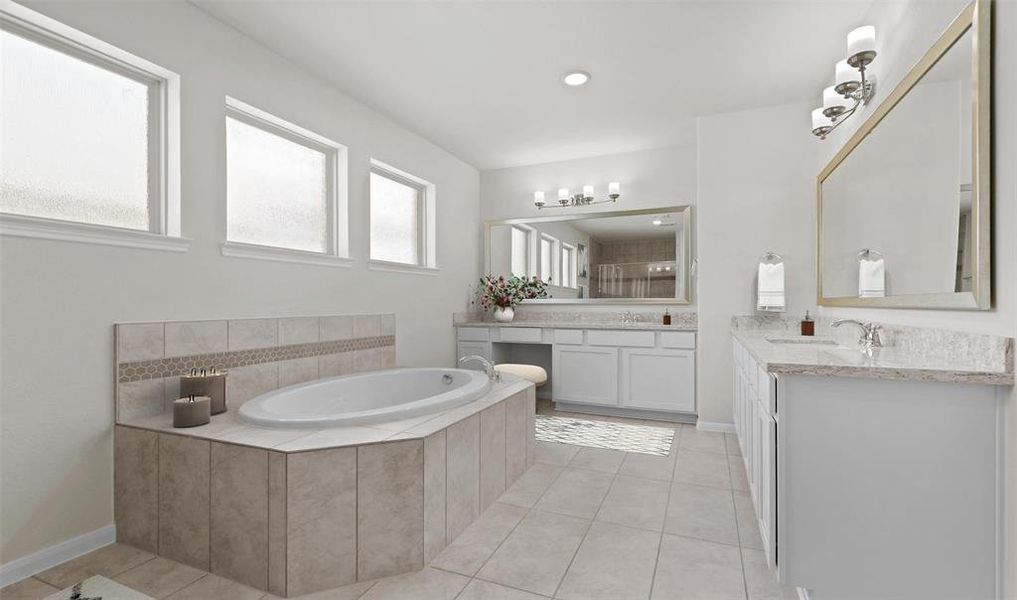 Relaxing owner's bath with dual sinks, freestanding tub, and shower (*Photo not of actual home and used for illustration purposes only.)