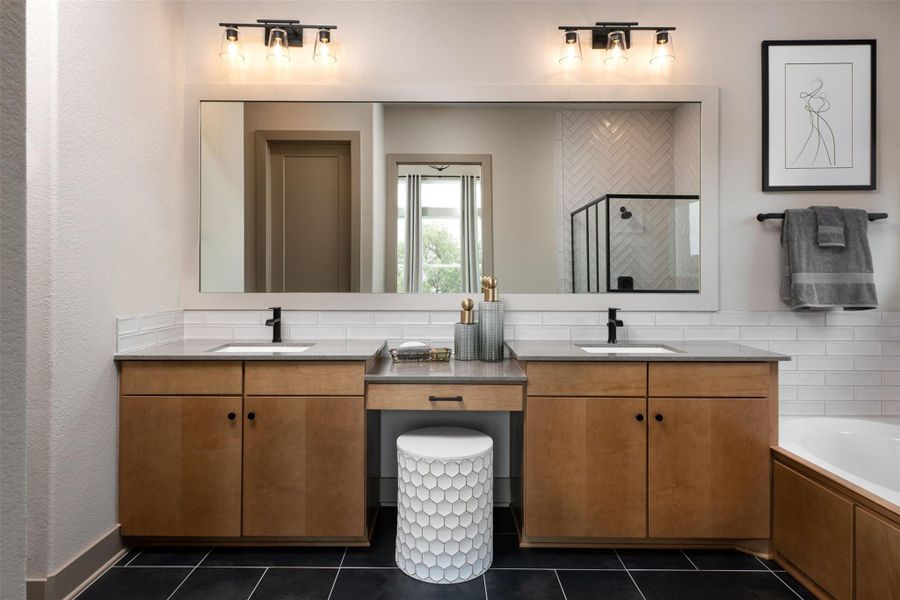 The en-suite bathroom offers a spa-like atmosphere with its elegant design, high end finishes, and tasteful lighting, creating a retreat within your own home.