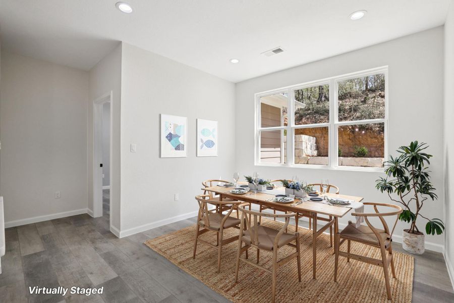 Virtually Staged Dining area featuring  light wood-type laminate flooring and recessed lighting