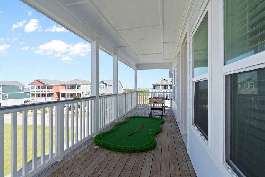 Located just outside the family bedrooms, this expansive front-facing balcony elevates everyday leisure with a foosball table and mini golf setup. Framed by elegant railings and scenic views, it’s a unique extension of the upstairs living space—perfect for unwinding in style or entertaining with a touch of coastal charm. Located just outside the family bedrooms, this expansive front-facing balcony elevates everyday leisure with a foosball table and mini golf setup. Framed by elegant railings and scenic views, it’s a unique extension of the upstairs living space—perfect for unwinding in style or entertaining with a touch of coastal charm.