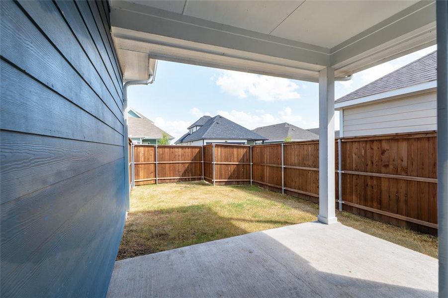 Fenced backyard with a patio area