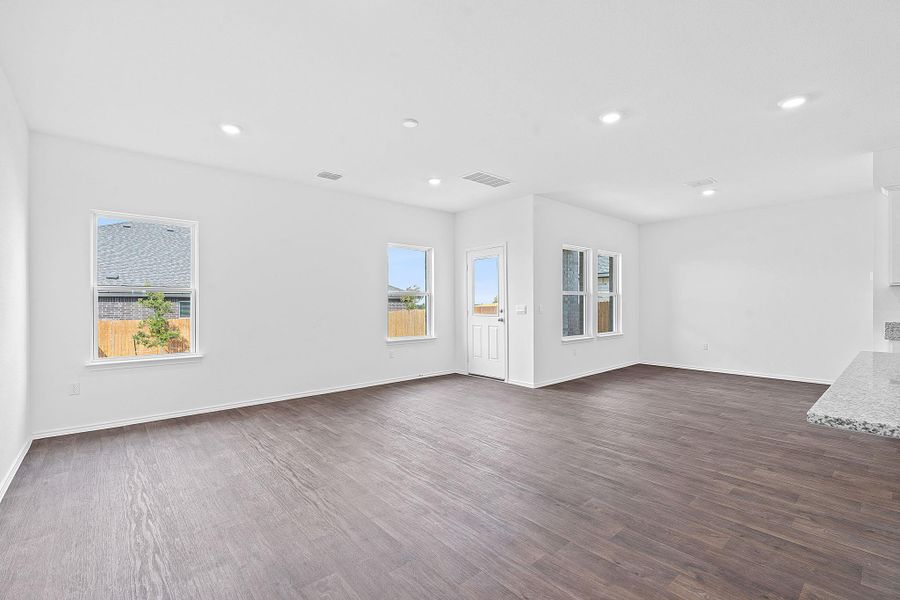 Empty room featuring dark wood-style flooring and recessed lighting Empty room featuring dark wood-style flooring and recessed lighting