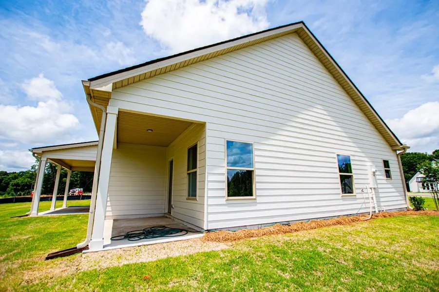 Exterior details and patio area of a home in WOODMONT RESERVE, Roopville (Image 34).