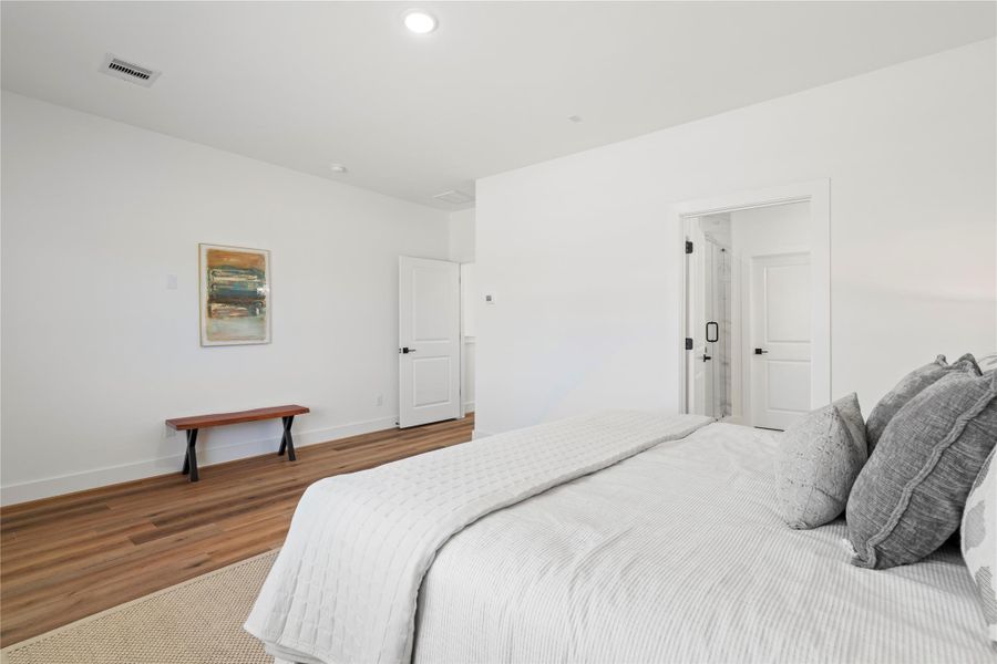 Large windows and an open layout make this primary suite feel bright, airy, and perfect for relaxation.