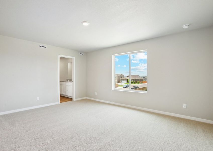 The master bedroom is spacious with a large window.