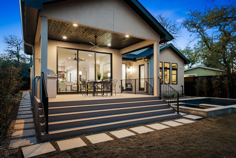 Rear view of house featuring a patio, ceiling fan, outdoor dining space, and stucco siding