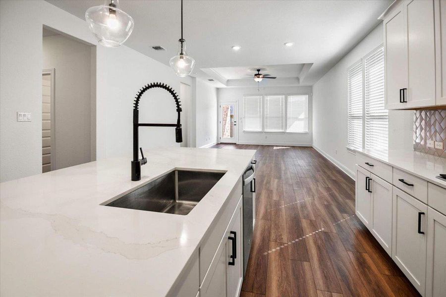 A well-appointed kitchen island offers generous counter space and seamless flow into the inviting living area.