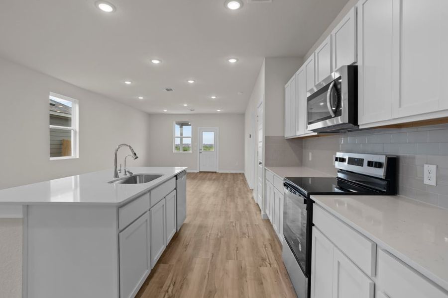 A kitchen with white cabinets. A kitchen with white cabinets.