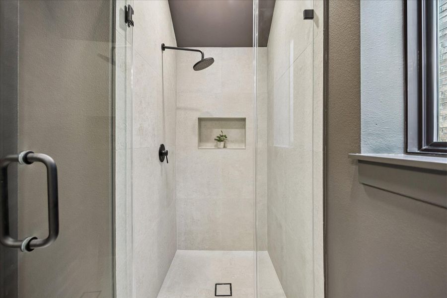 Walk-in shower with frameless glass doors. Walk-in shower with frameless glass doors.