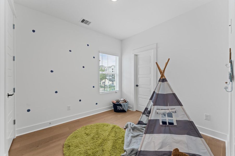 This secondary bedroom on the second floor exudes warmth and sophistication with its rich engineered hardwood flooring, adding a touch of elegance to the space. The smooth, durable surface enhances the room’s clean lines and complements a variety of décor from cozy and traditional to sleek and modern. Natural light dances across the wood grain, creating a serene atmosphere ideal for rest, work, or creative pursuits. This secondary bedroom on the second floor exudes warmth and sophistication with its rich engineered hardwood flooring, adding a touch of elegance to the space. The smooth, durable surface enhances the room’s clean lines and complements a variety of décor from cozy and traditional to sleek and modern. Natural light dances across the wood grain, creating a serene atmosphere ideal for rest, work, or creative pursuits.
