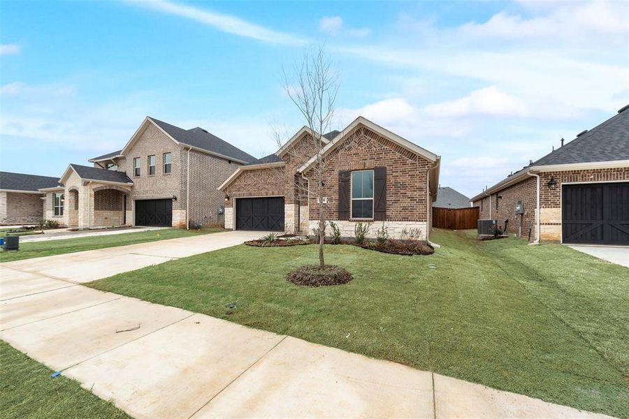 Front exterior of a new home in Spiritas Ranch, Little Elm, TX, highlighting curb appeal (Image 20).