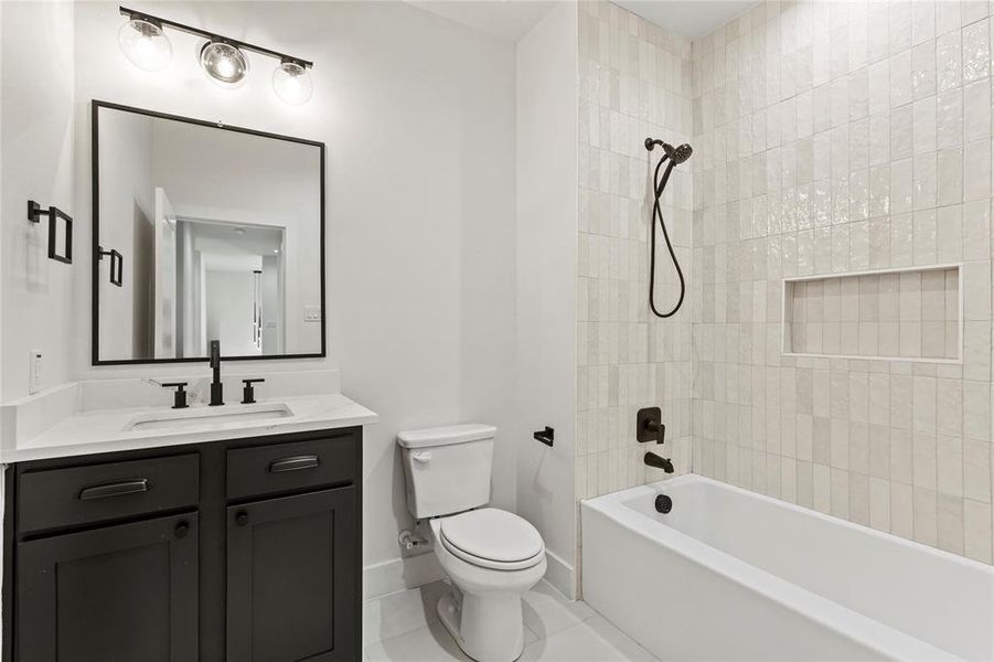 Full bath featuring vanity,  shower combination, and tile patterned floors