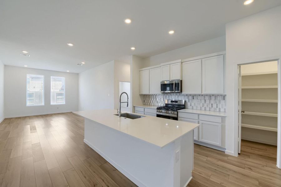 Expansive walk-in pantry with ample storage space.