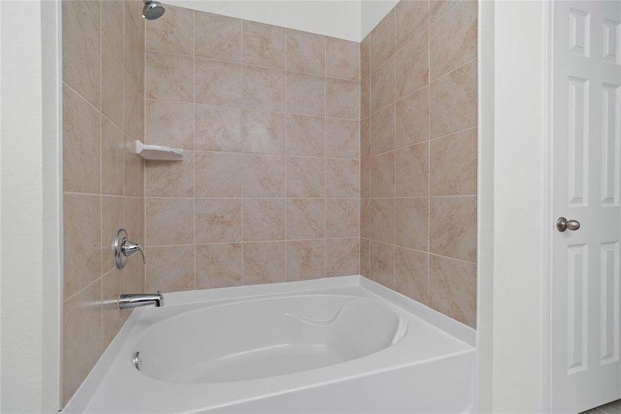 Additional view of the primary bathroom featuring the oversized tub/shower combination.