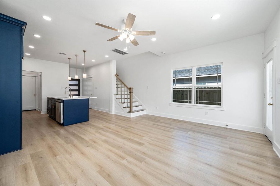 Different perspective highlighting the open-concept layout and smooth flow between the living area and kitchen.