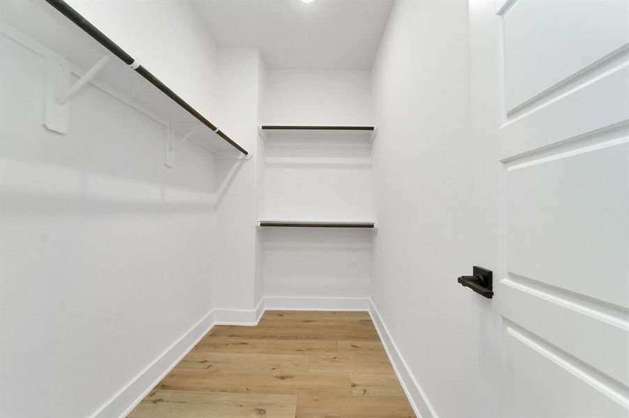 Primary bedroom walk in closet