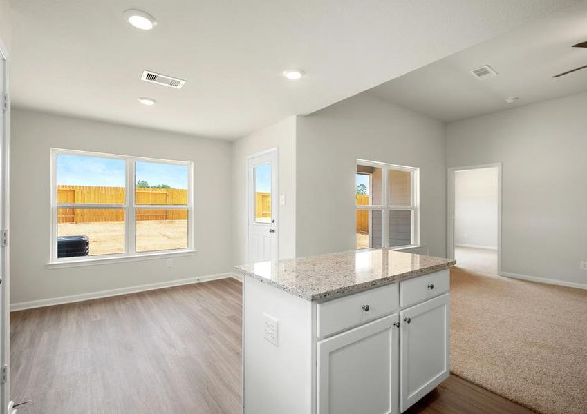 The dining room is connected to the kitchen and the family room.