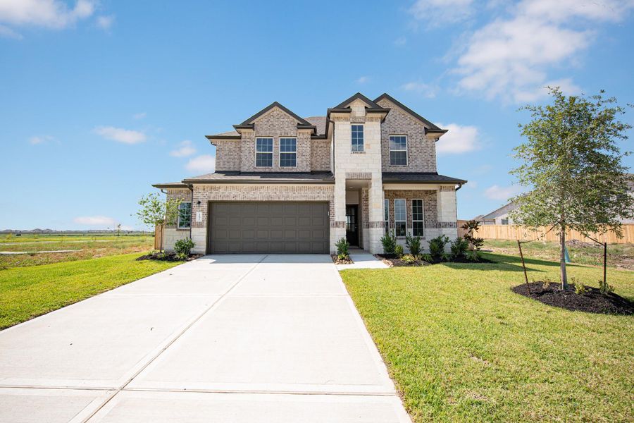 Front exterior of a new home in River Ranch, Dayton, TX, highlighting curb appeal (Image 17).