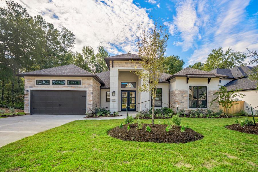 Front exterior of a new home in The Woodlands Hills, Willis, TX, highlighting curb appeal (Image 28). Front exterior of a new home in The Woodlands Hills, Willis, TX, highlighting curb appeal (Image 28).
