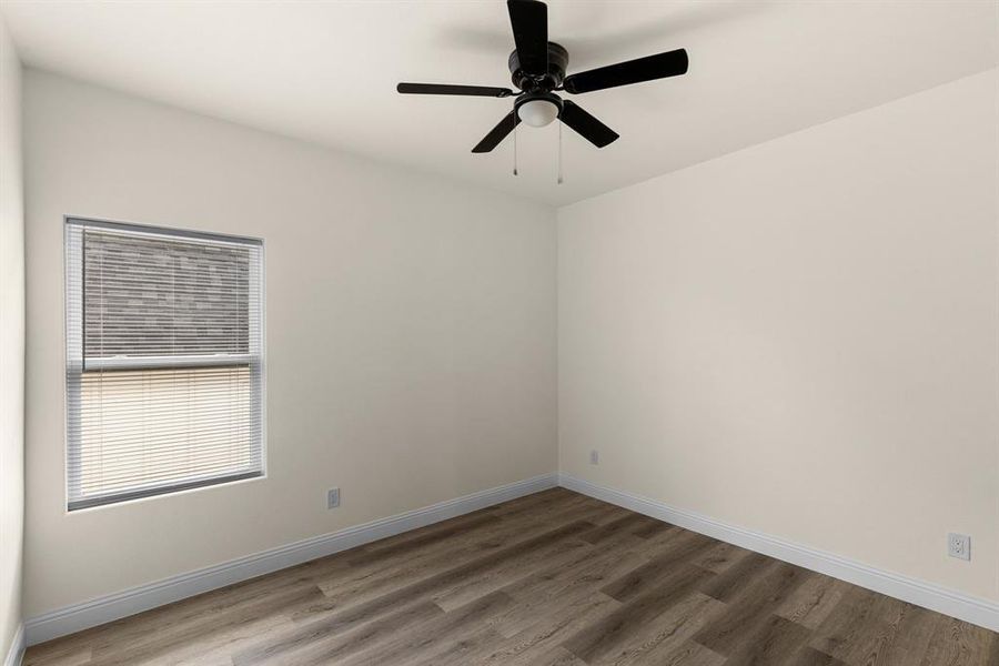 Unfurnished room with ceiling fan and wood-type flooring