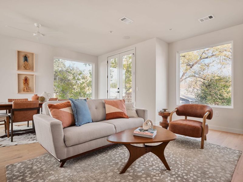 Living area with light wood-style flooring and ceiling fan