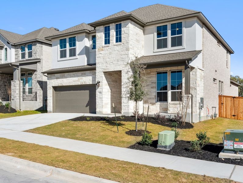 Front exterior of a new home in Heritage, Dripping Springs, TX, highlighting curb appeal (Image 24). Front exterior of a new home in Heritage, Dripping Springs, TX, highlighting curb appeal (Image 24).