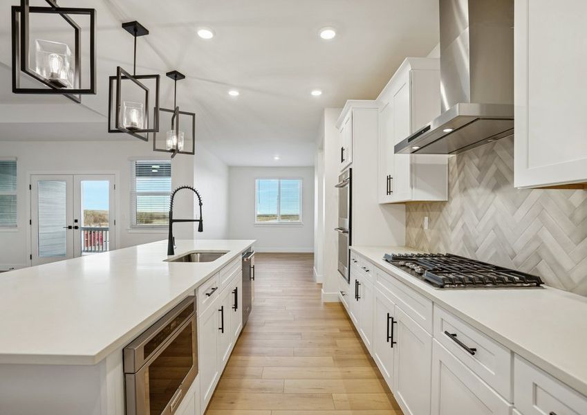The kitchen has gorgeous white cabinetry.