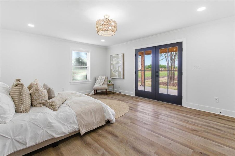 This room features hardwood style flooring and a contemporary light fixture This room features hardwood style flooring and a contemporary light fixture