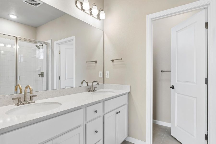 A bathroom with a large mirror.