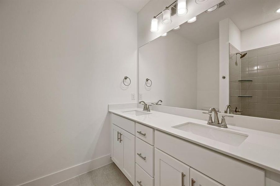 Guests will enjoy their own vanity space in this thoughtfully designed guest bath.