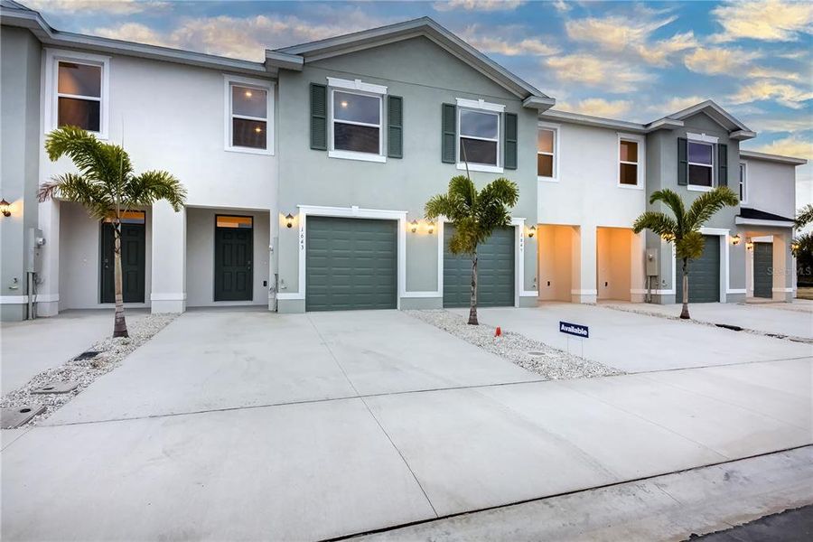 Front exterior of a new home in The Gardens at Bay Street, Sarasota, FL, highlighting curb appeal (Image 19). Front exterior of a new home in The Gardens at Bay Street, Sarasota, FL, highlighting curb appeal (Image 19).