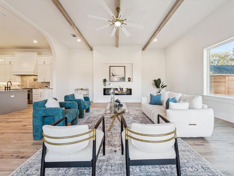 Living room featuring ceiling fan, sink, and light wood-type flooring