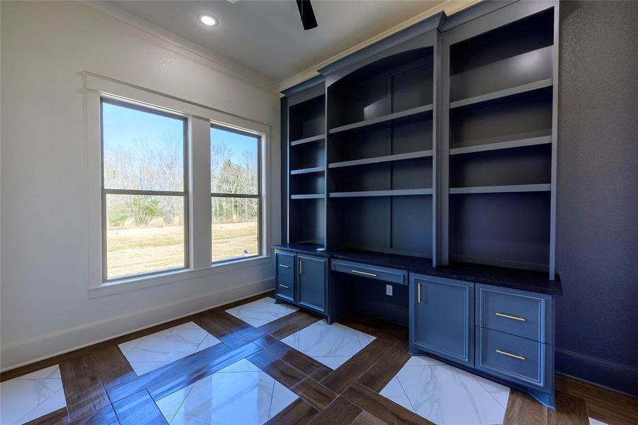 Unfurnished office featuring a ceiling fan, built in desk, crown molding, and recessed lighting