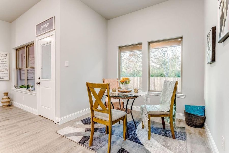 Dining space with light hardwood / wood-style floors