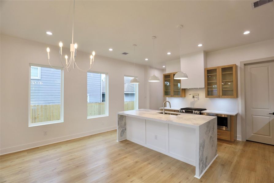 The open floor plan offers seamless access from the kitchen to the dining room, enhancing the flow and making entertaining effortless. 3 large windows enhance the entire area. The open floor plan offers seamless access from the kitchen to the dining room, enhancing the flow and making entertaining effortless. 3 large windows enhance the entire area.