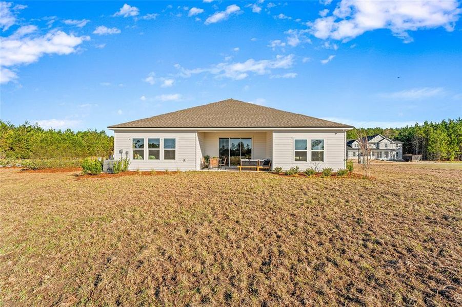 Front exterior of a new home in The Cypress Series at Reserve East, Flagler Beach, FL, highlighting curb appeal (Image 27). Front exterior of a new home in The Cypress Series at Reserve East, Flagler Beach, FL, highlighting curb appeal (Image 27).