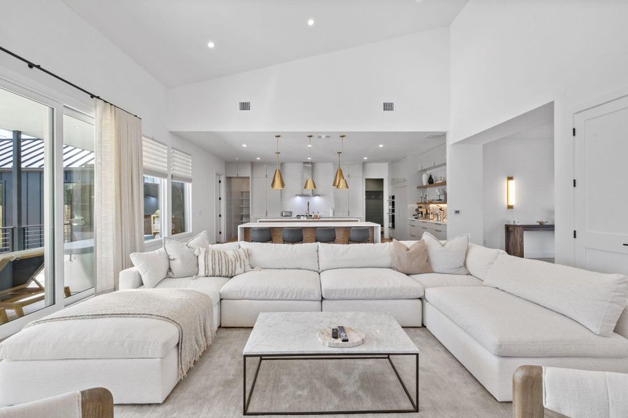 Living area with recessed lighting and vaulted ceiling