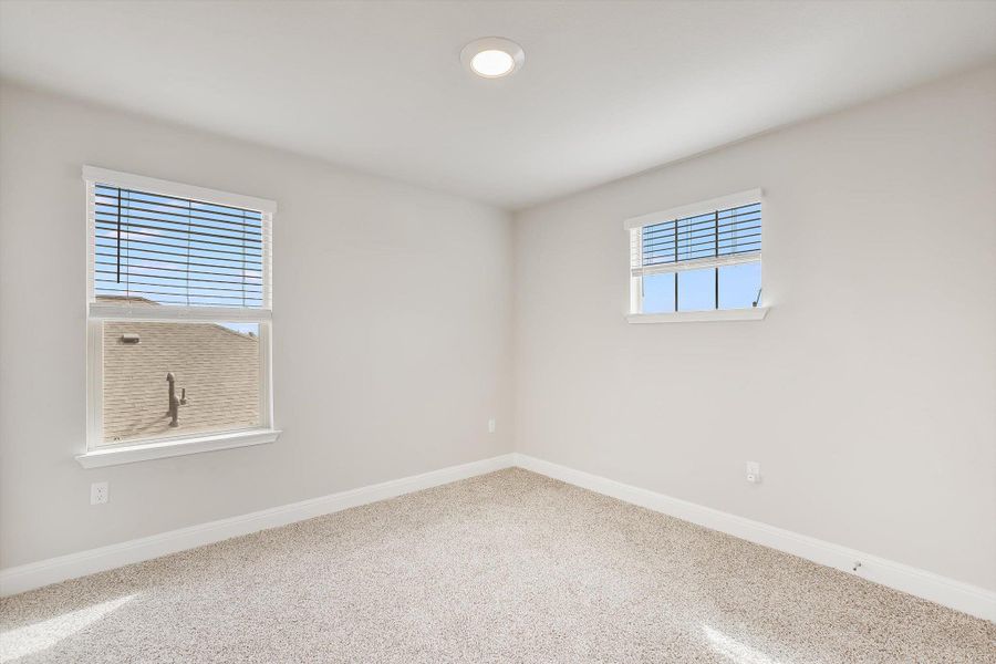 Carpeted empty room featuring baseboards