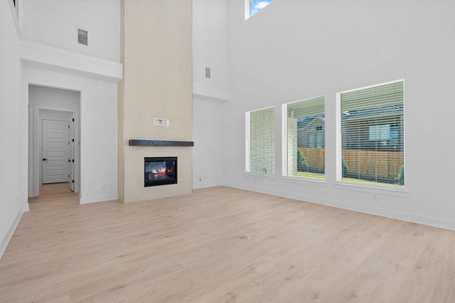 Family Room with soaring ceiling & fireplace