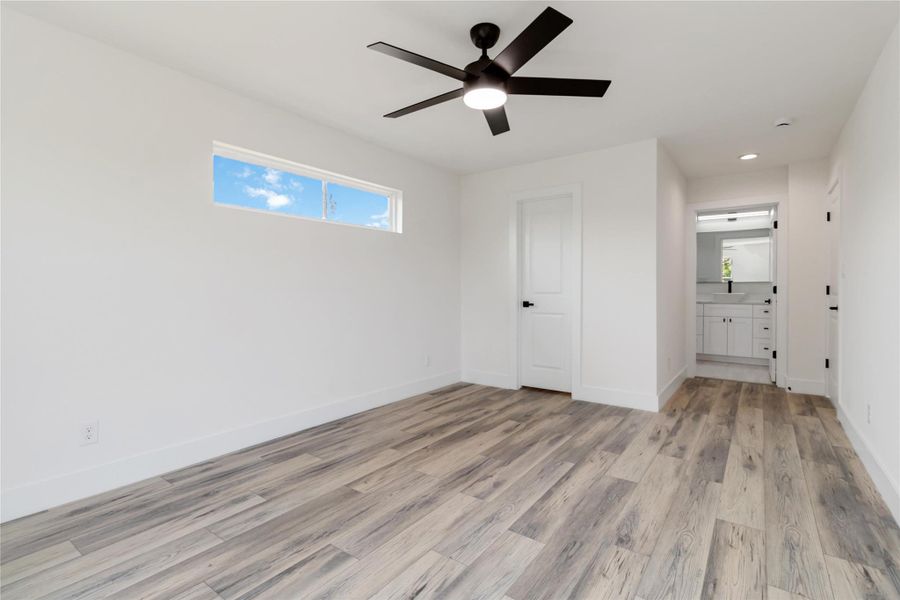 Transom window above the bed area brings in soft natural light while maintaining privacy. Transom window above the bed area brings in soft natural light while maintaining privacy.