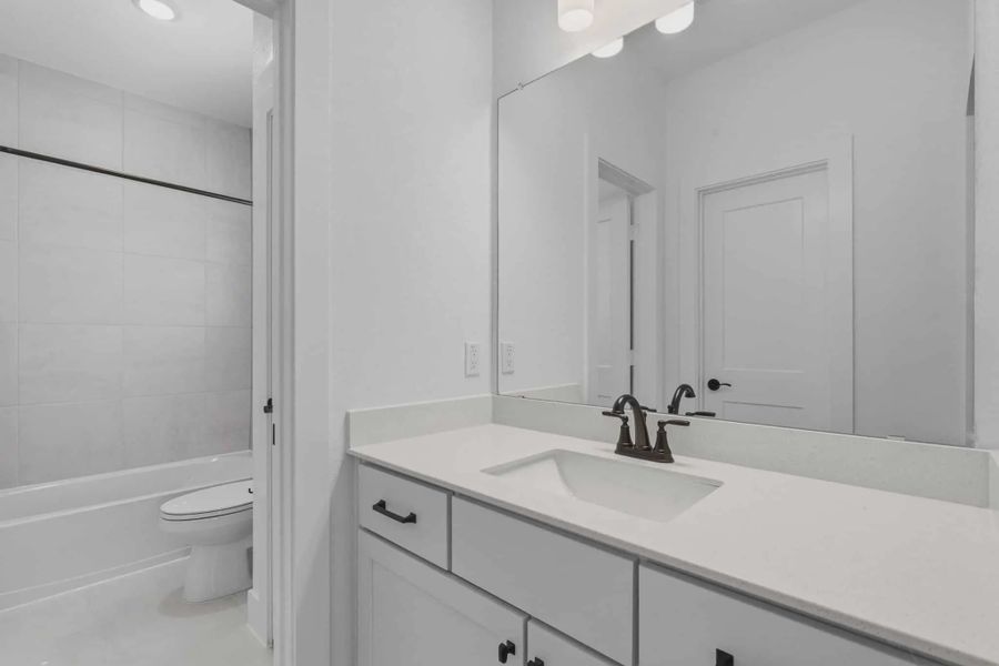 Representative furnished interior of a home built from the Sorenstam by Chesmar Homes in Riceland Alley Loads, Mont Belvieu (Image 45).