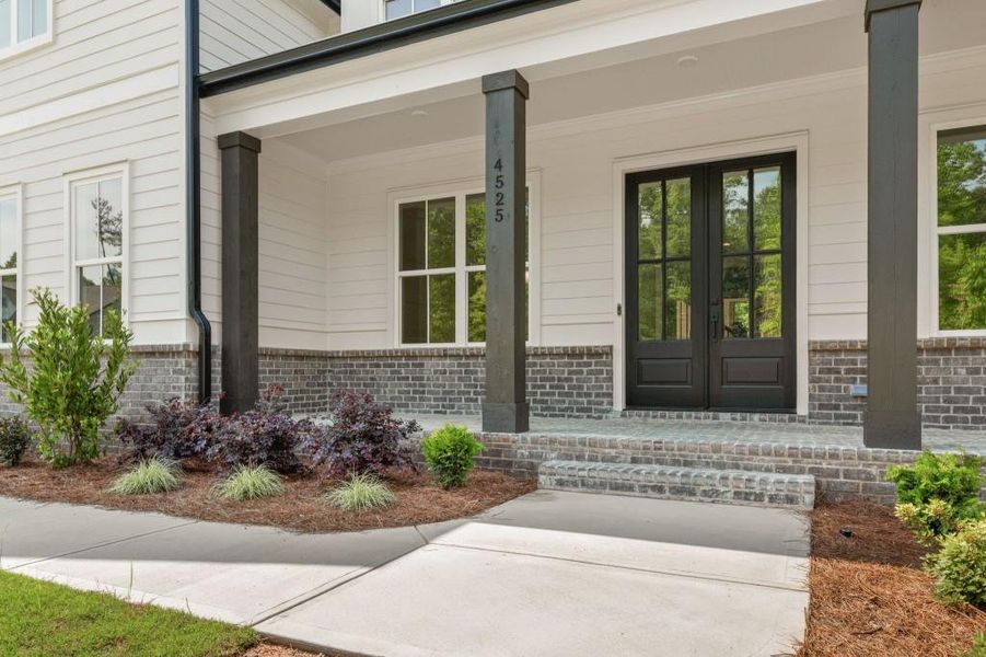 Front exterior of a new home in Arden on Lanier, Cumming, GA, highlighting curb appeal (Image 2). Front exterior of a new home in Arden on Lanier, Cumming, GA, highlighting curb appeal (Image 2).