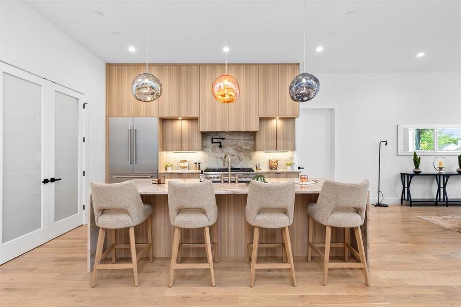Kitchen with Large Island and Eye-Catching Light Fixtures!